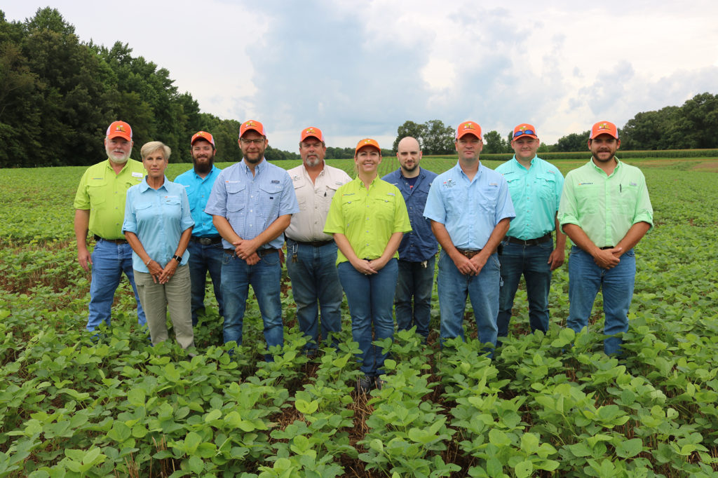 The staff of the AgResearch and Education Center at Milan pose in a green field